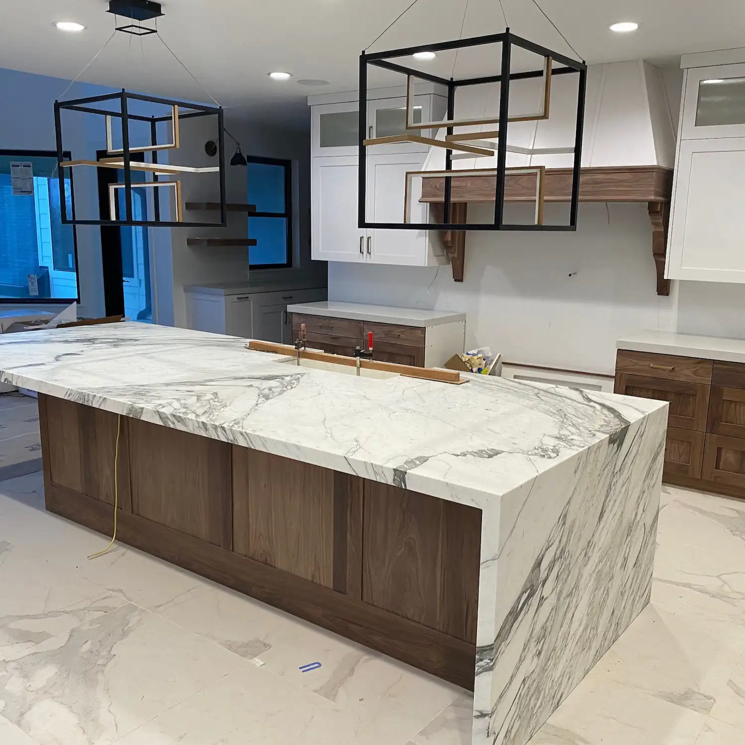 Marble waterfall kitchen island with matching floor