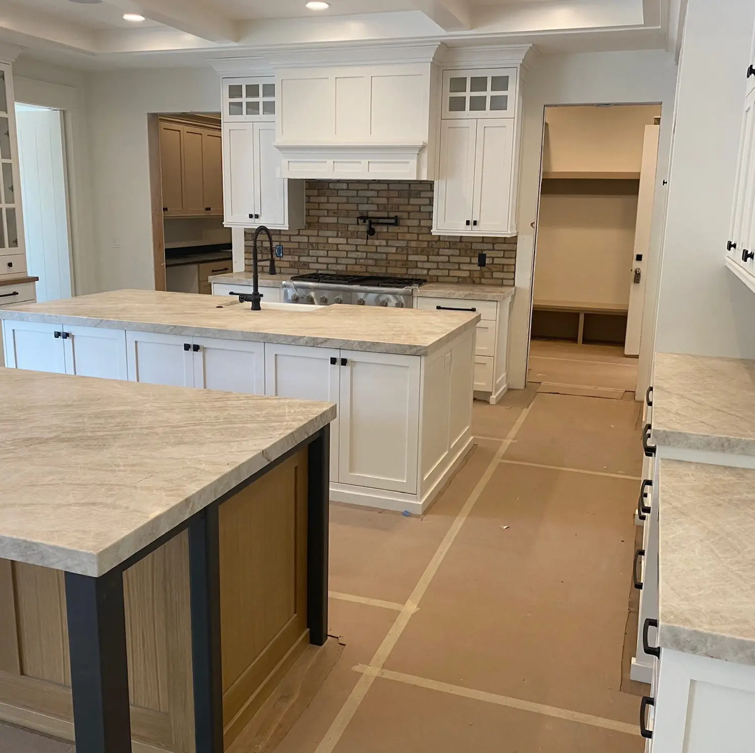 Traditional white kitchen with light marble countertops